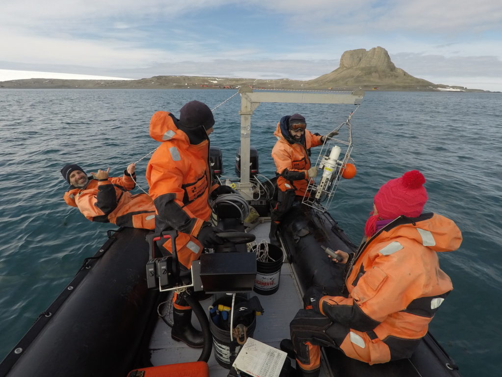 A team of scientists making CTD casts on a small boat in Potter Cove, Antarctica